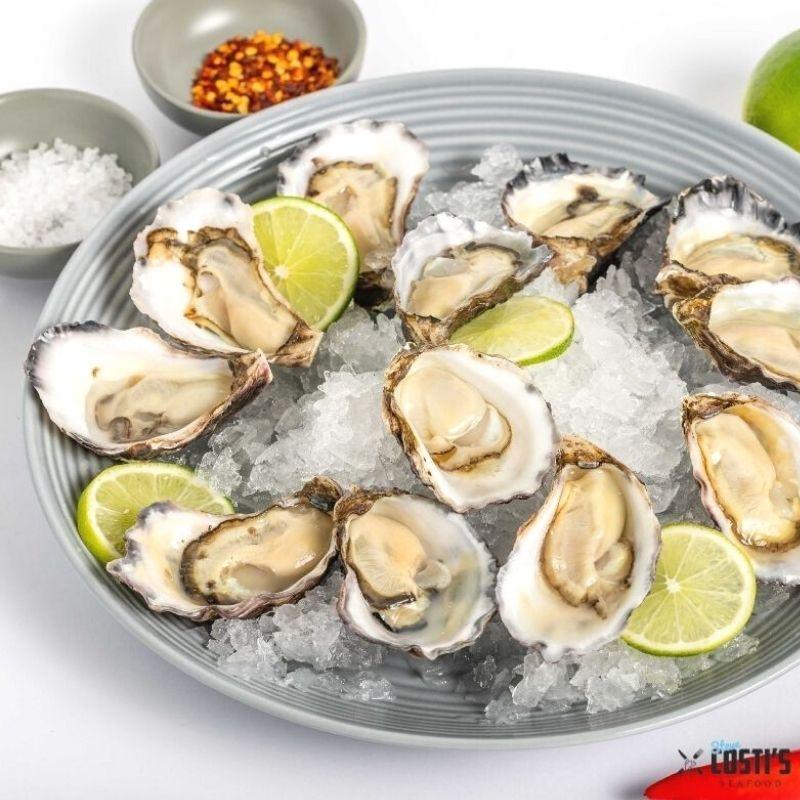 Sydney rock oysters shucked in a plate with ice and limes from Steve Costi seafood