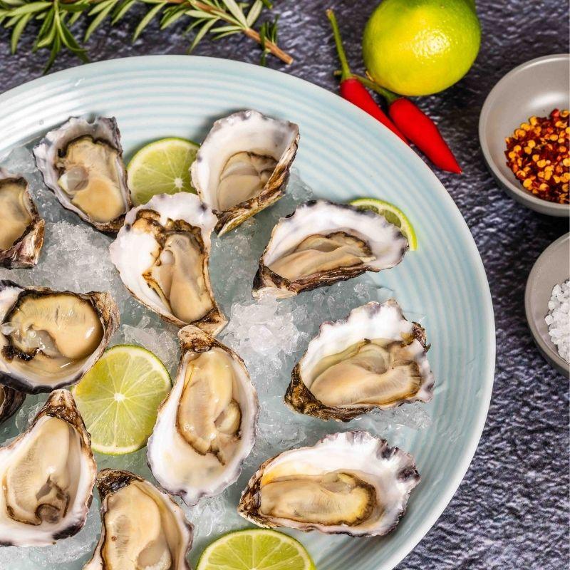 Fresh Sydney rock oysters shucked  in a plate with ice and condiments from Steve Costi seafood